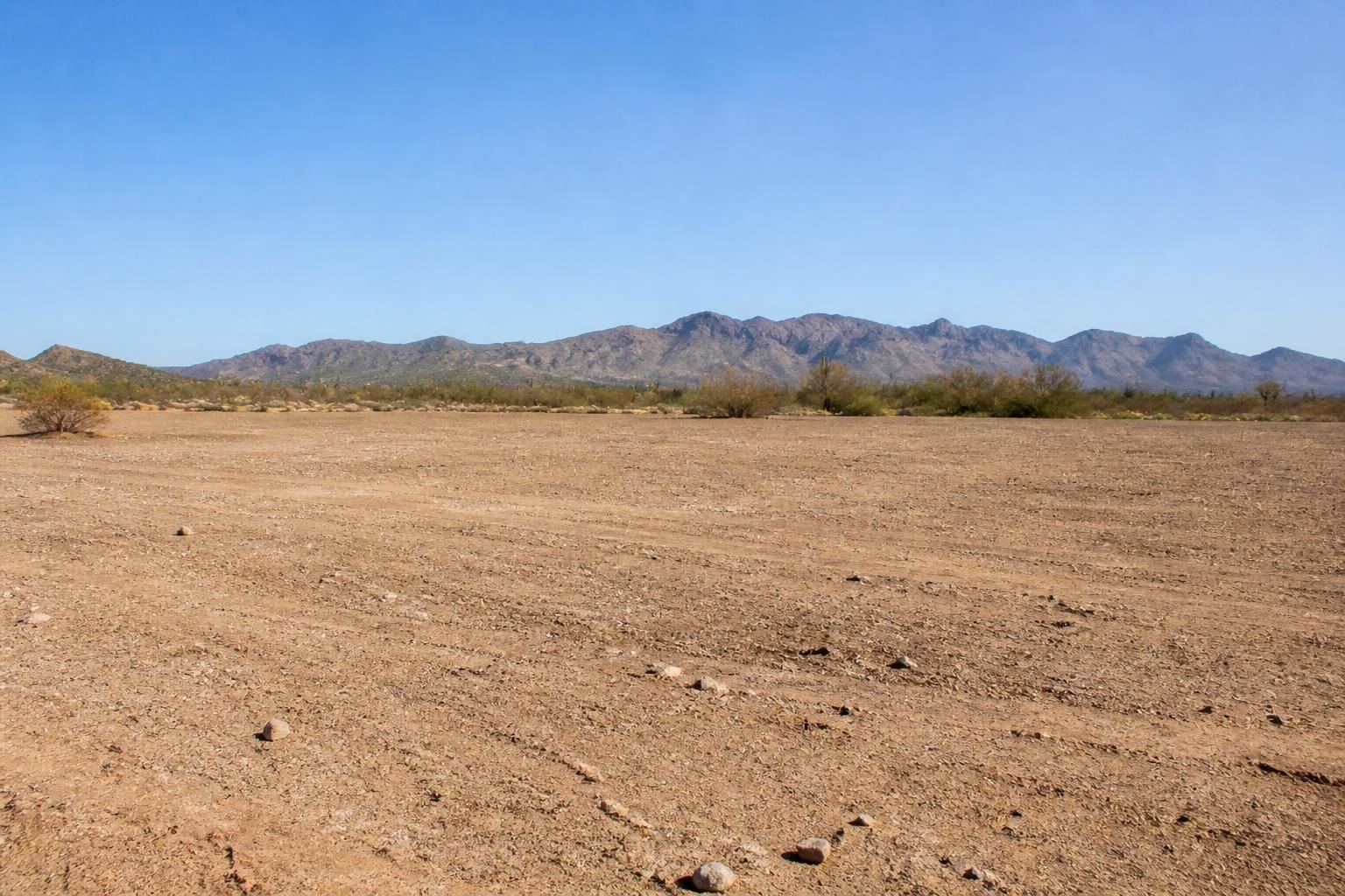 Cleared desert lot with open terrain ready for use.